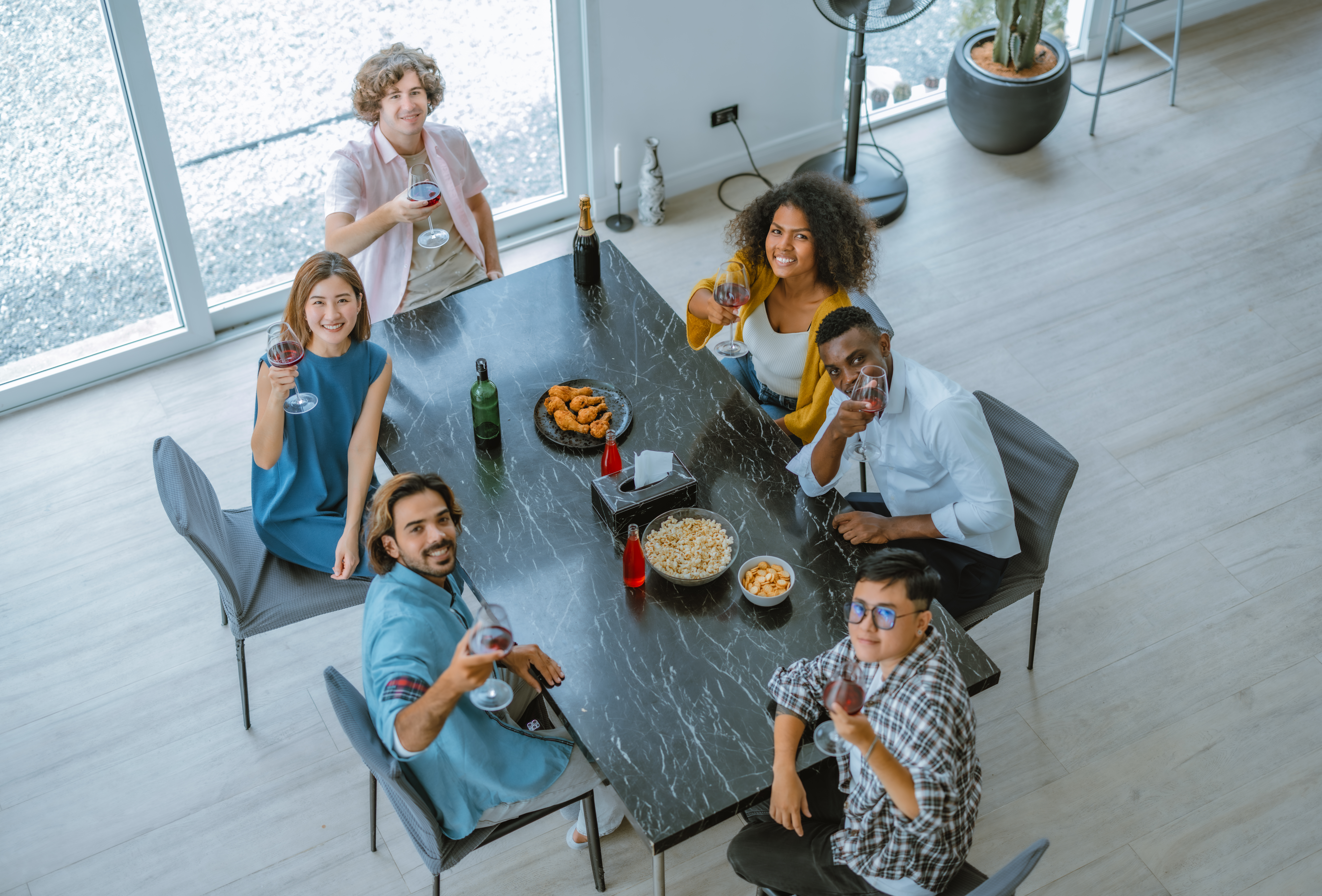 Vibrant multicultural reunion of friends, filled with laughter, diverse stories, exciting interaction. A blend of togetherness, bonding, celebration, where music, dance, chat create joyful atmosphere