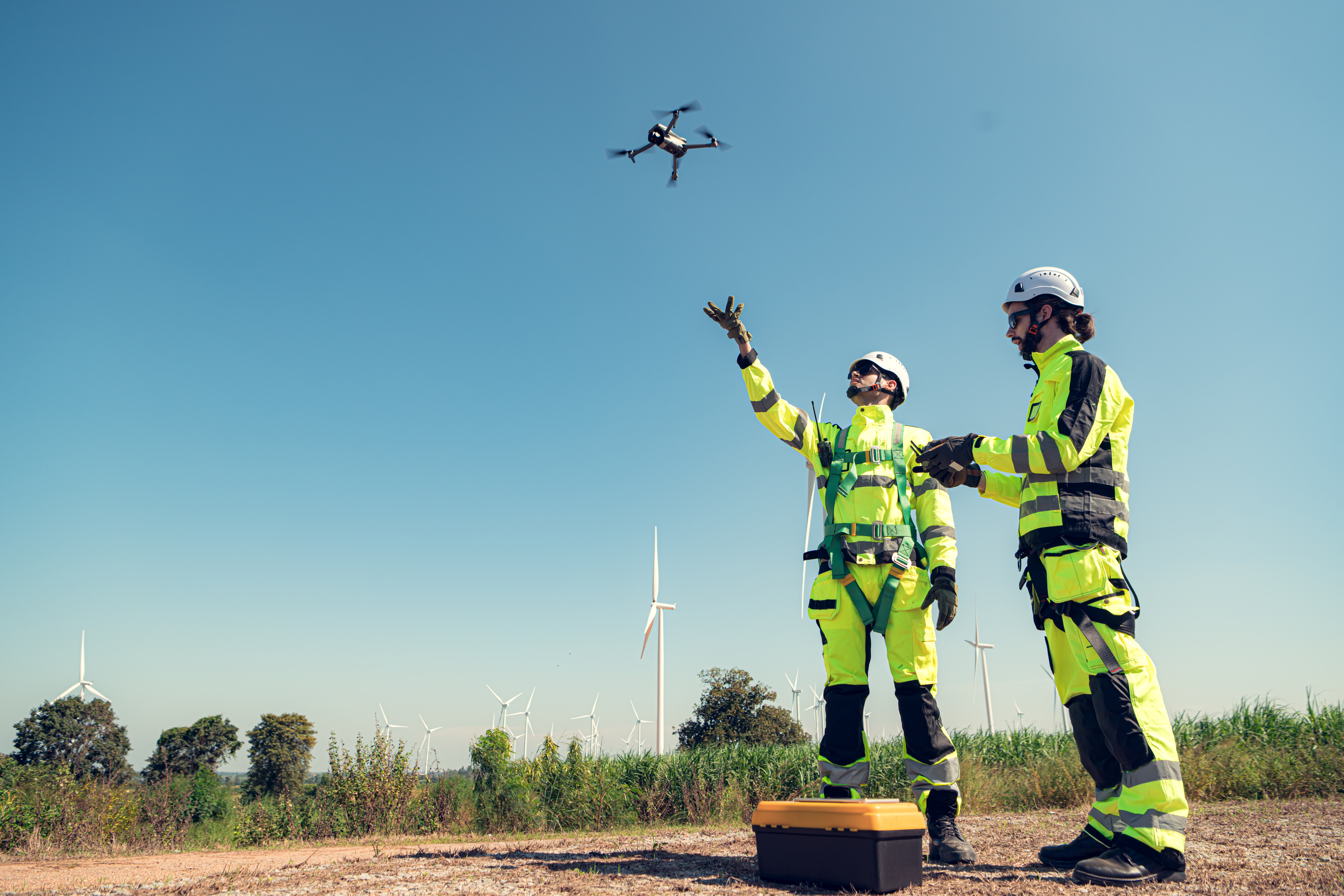 The engineering team is surveying the area to install a large wind turbine for converting wind energy into electricity